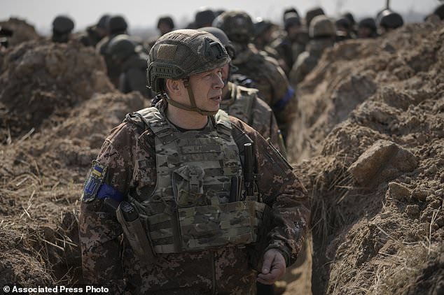 Col. Gen. Oleksandr Syrskyi, top military commander in charge of the defense of the Ukrainian capital, walks in a trench at a position north of the capital Kyiv, Ukraine, Tuesday, March 29, 2022. The first face-to-face talks in two weeks between Russia and Ukraine began Tuesday in Turkey, raising flickering hopes there could be progress toward ending a war that has ground into a bloody campaign of attrition